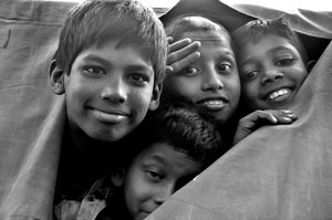 Destitute Children Look Through a Torn Canvas of a Police Van at Dhaka City, Bangladesh